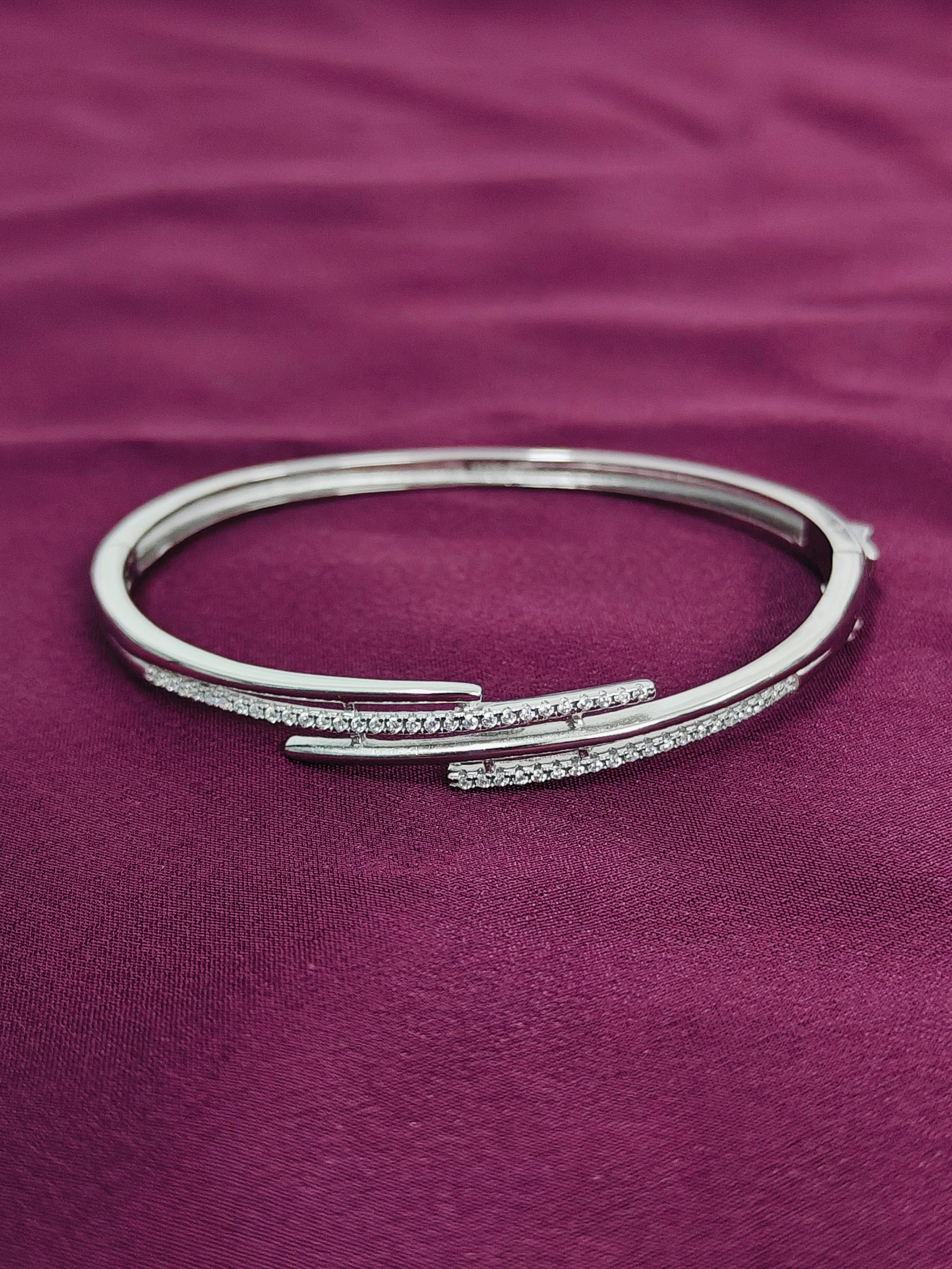 Silver bracelet on a purple fabric background