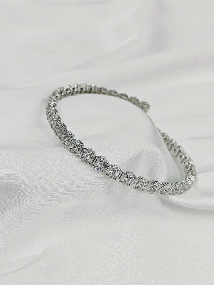 Silver bracelet on a white fabric background