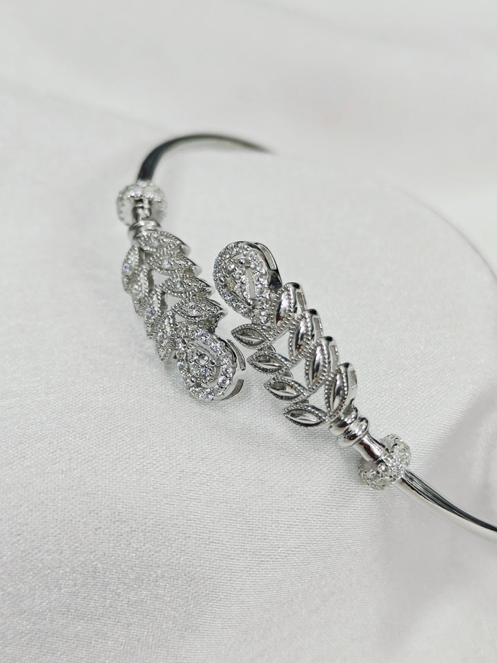 Silver headband with decorative elements on a light gray background