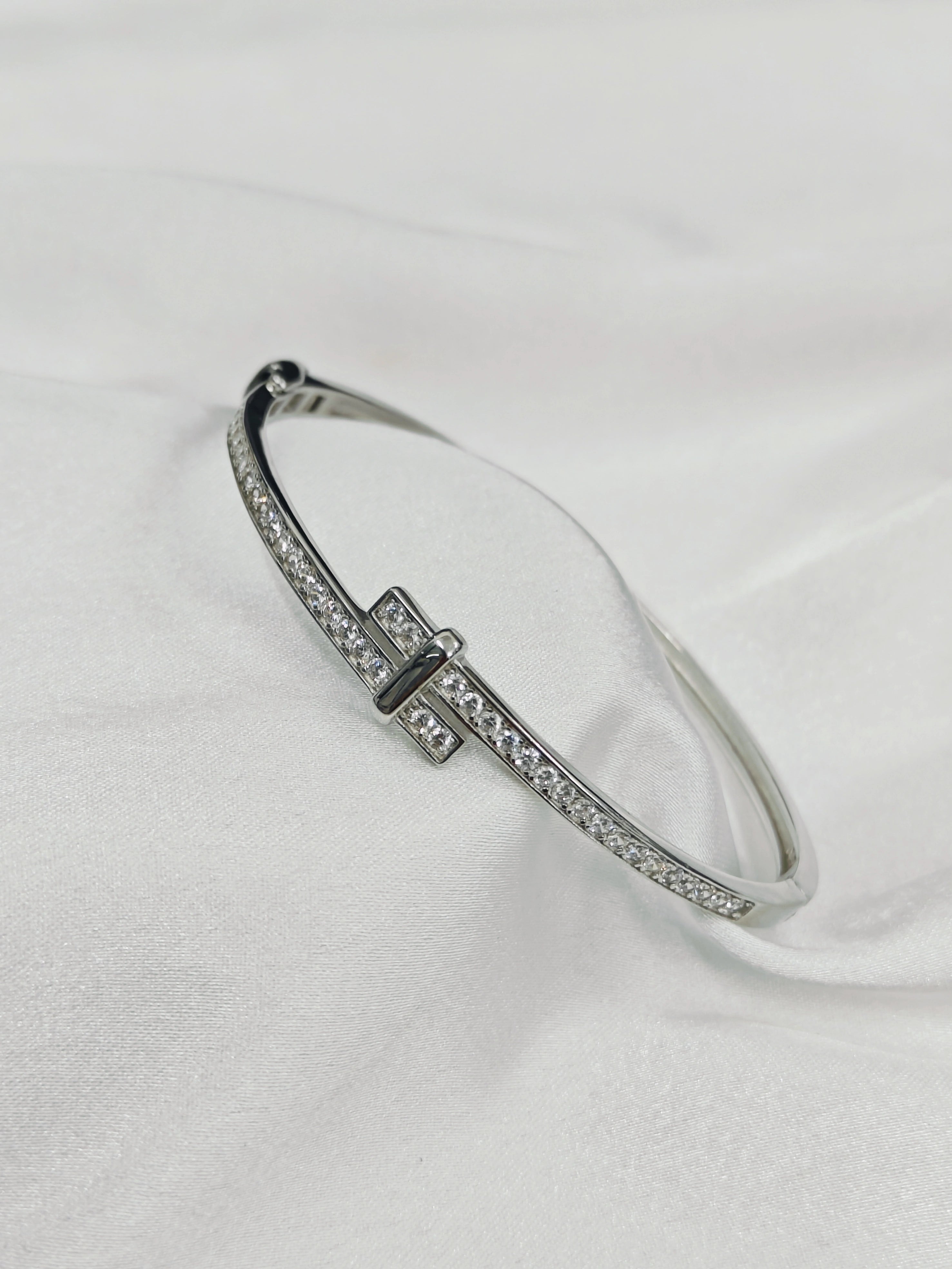 Silver bracelet with small diamonds on a white background