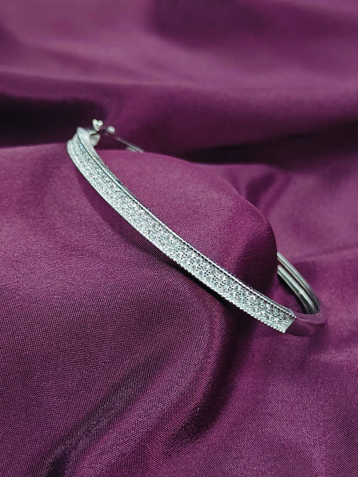 Silver headband with rhinestones on a purple fabric background