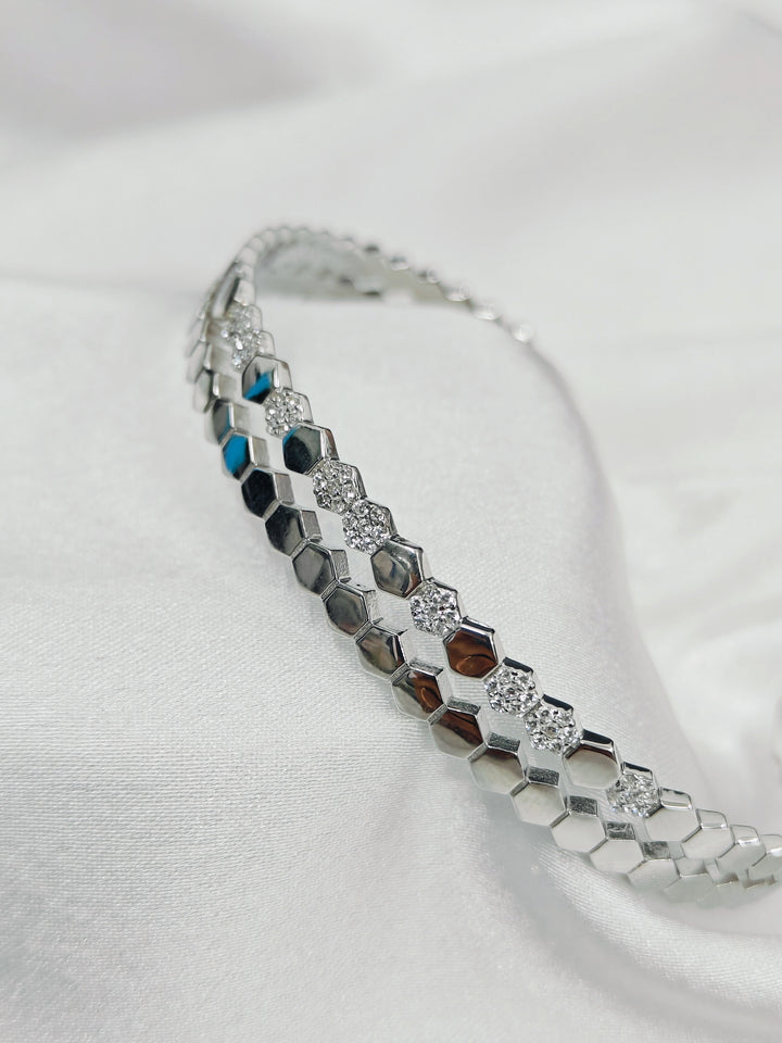 Silver bracelet with multicolored stones on a white background