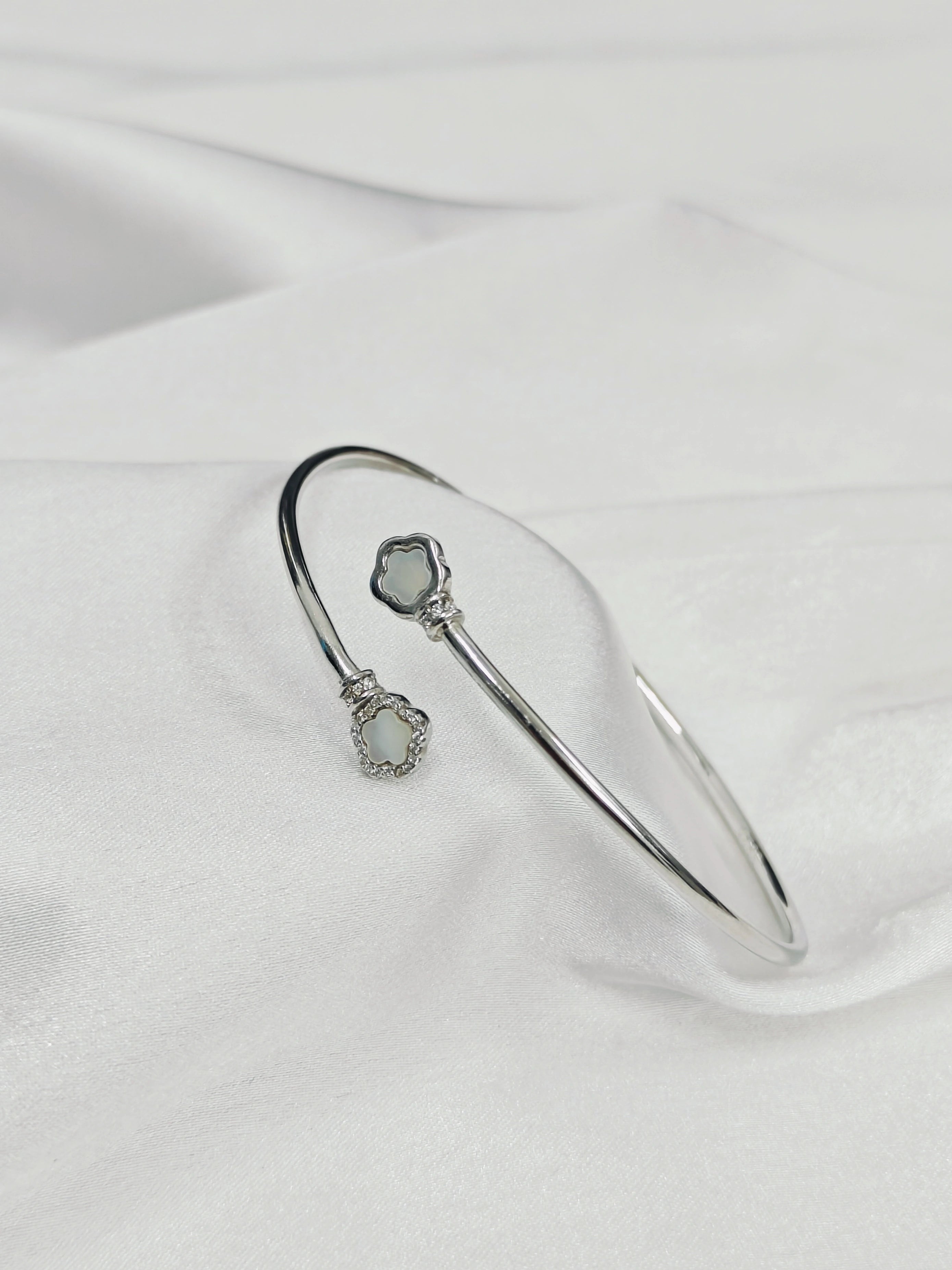 Silver bracelet with gemstone on a white fabric background