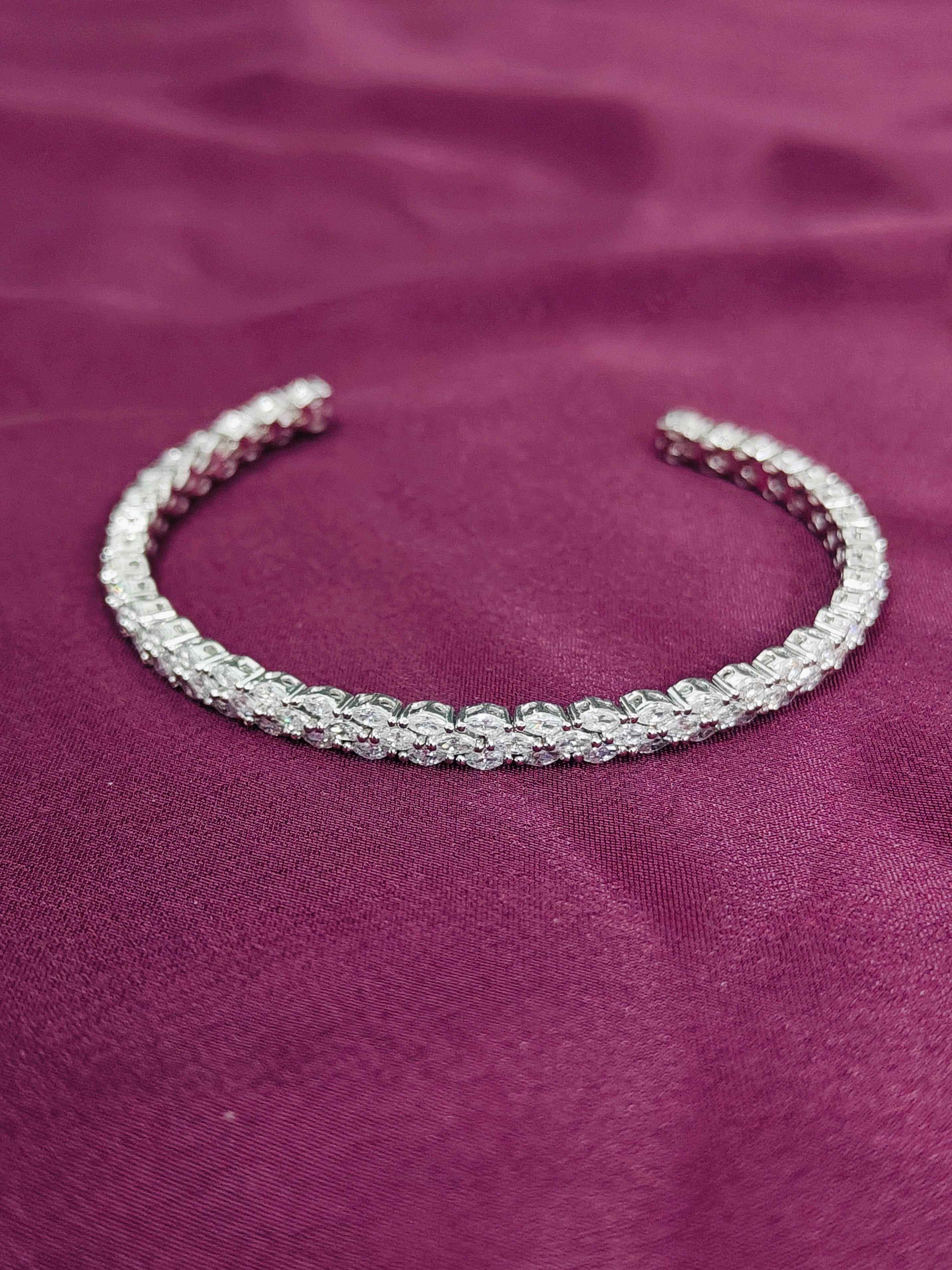 Silver bracelet on a purple fabric background