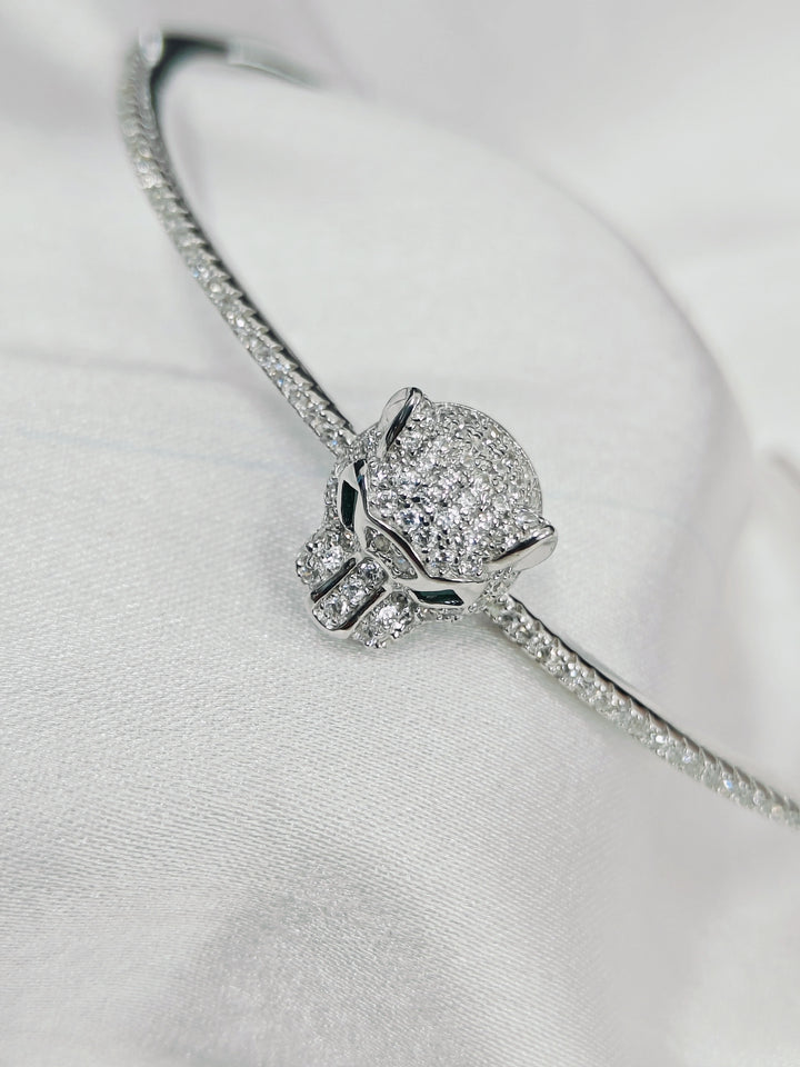 Silver bracelet with a heart-shaped clasp on a light gray background