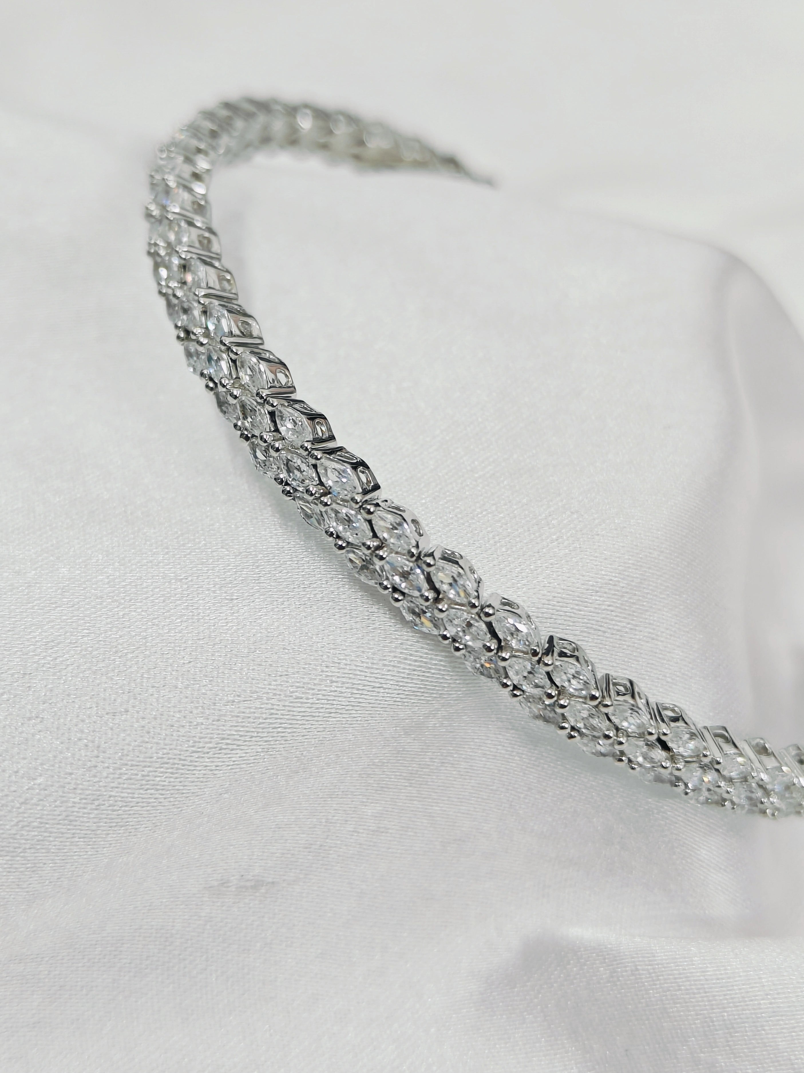 Silver headband with clear gemstones on a white background