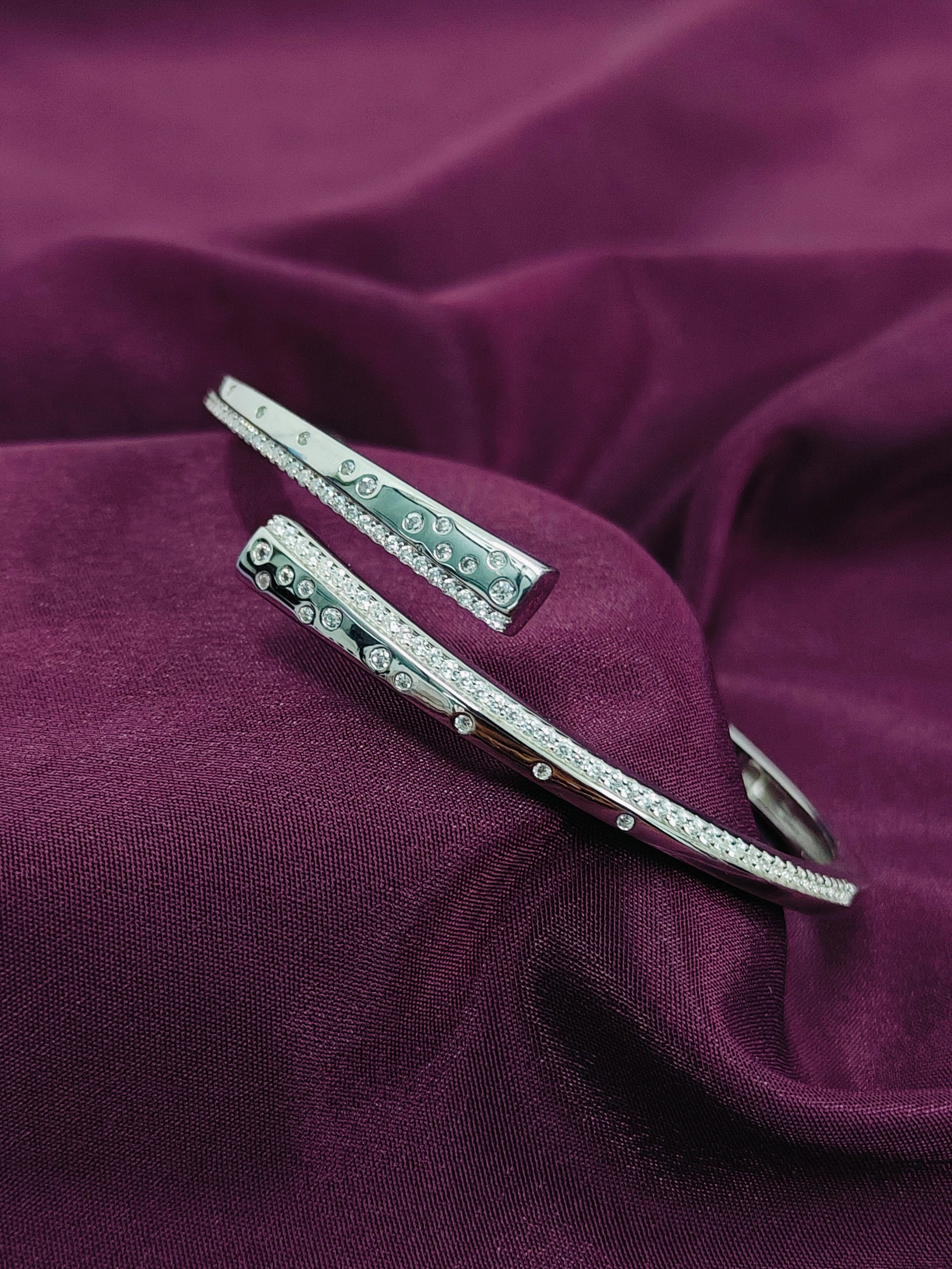Silver hair clips with gemstones on a purple fabric background