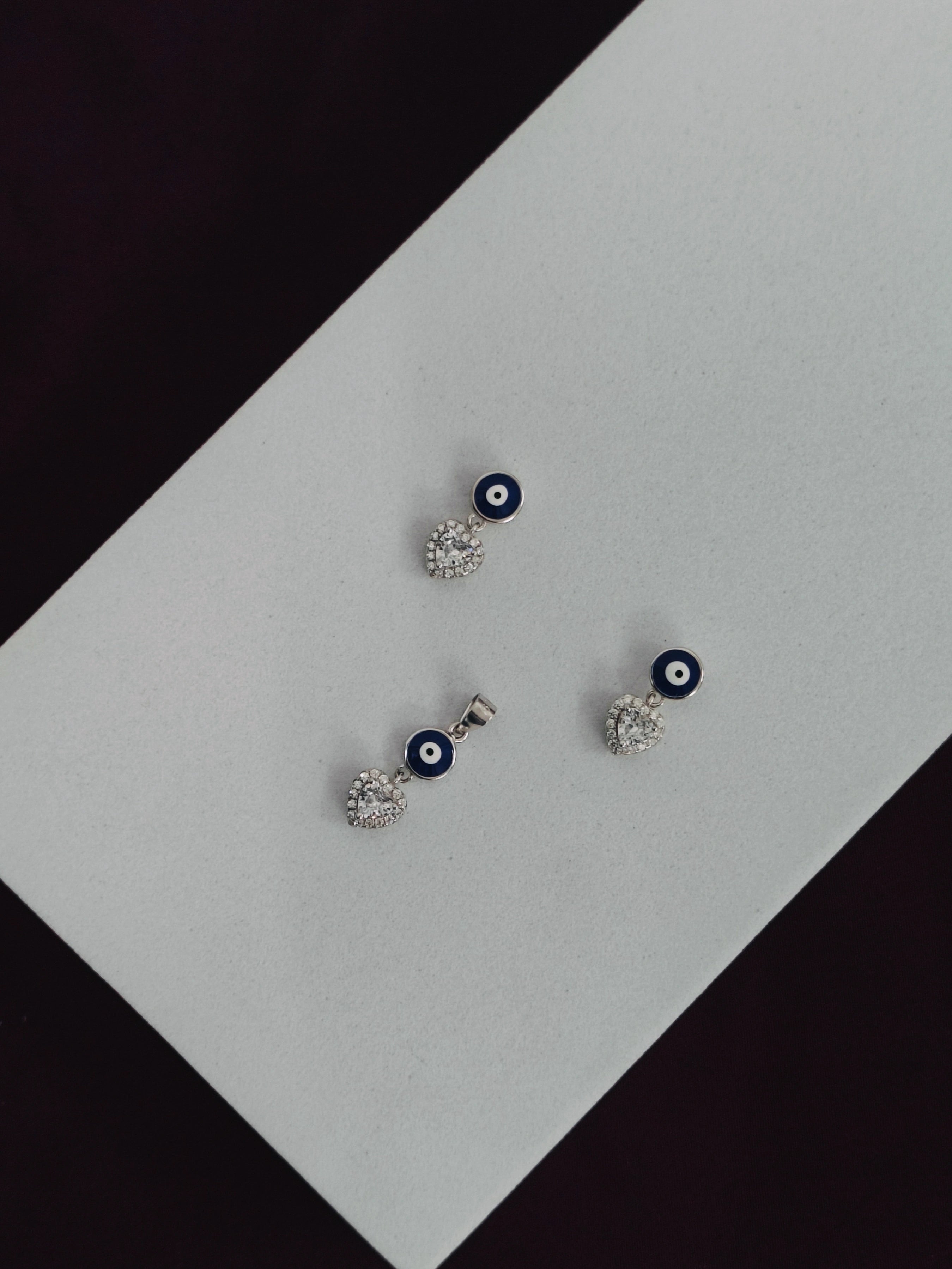 Set of earrings with blue and white accents on a black and white background