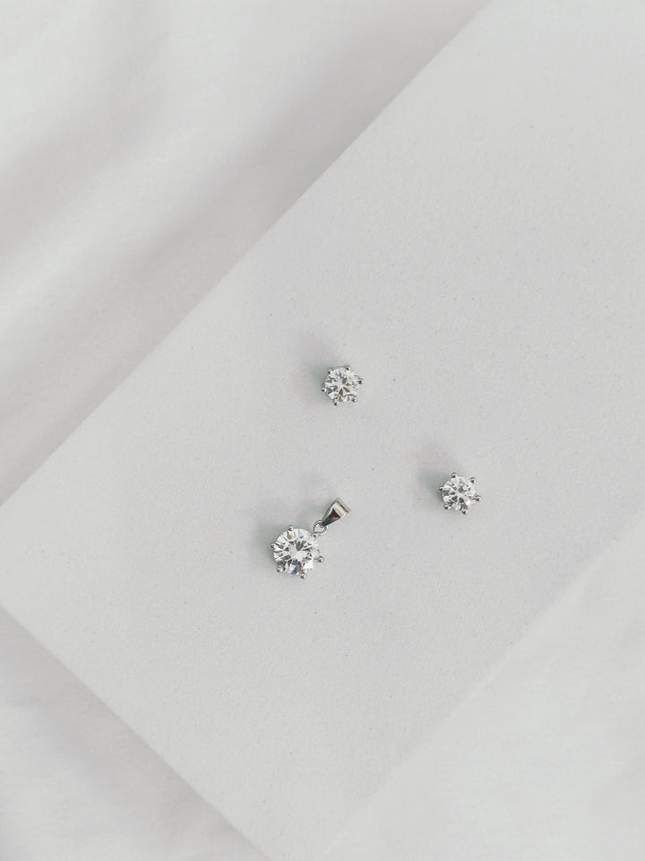 Silver stud earrings on a light gray background