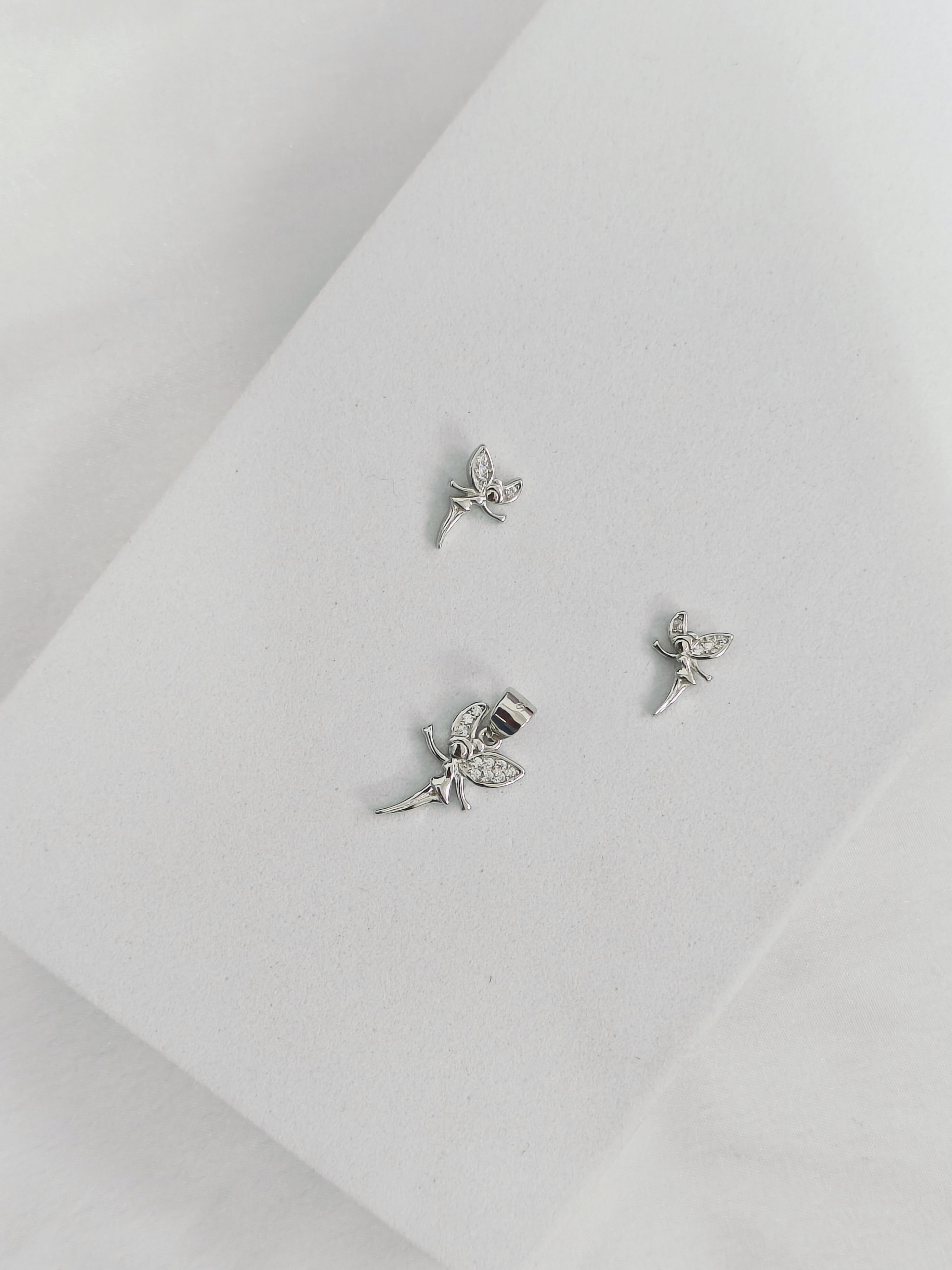 Silver fairy earrings on a light gray background