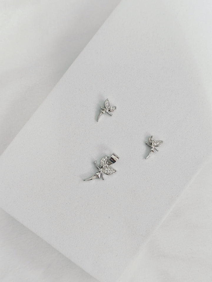 Silver fairy earrings on a light gray background