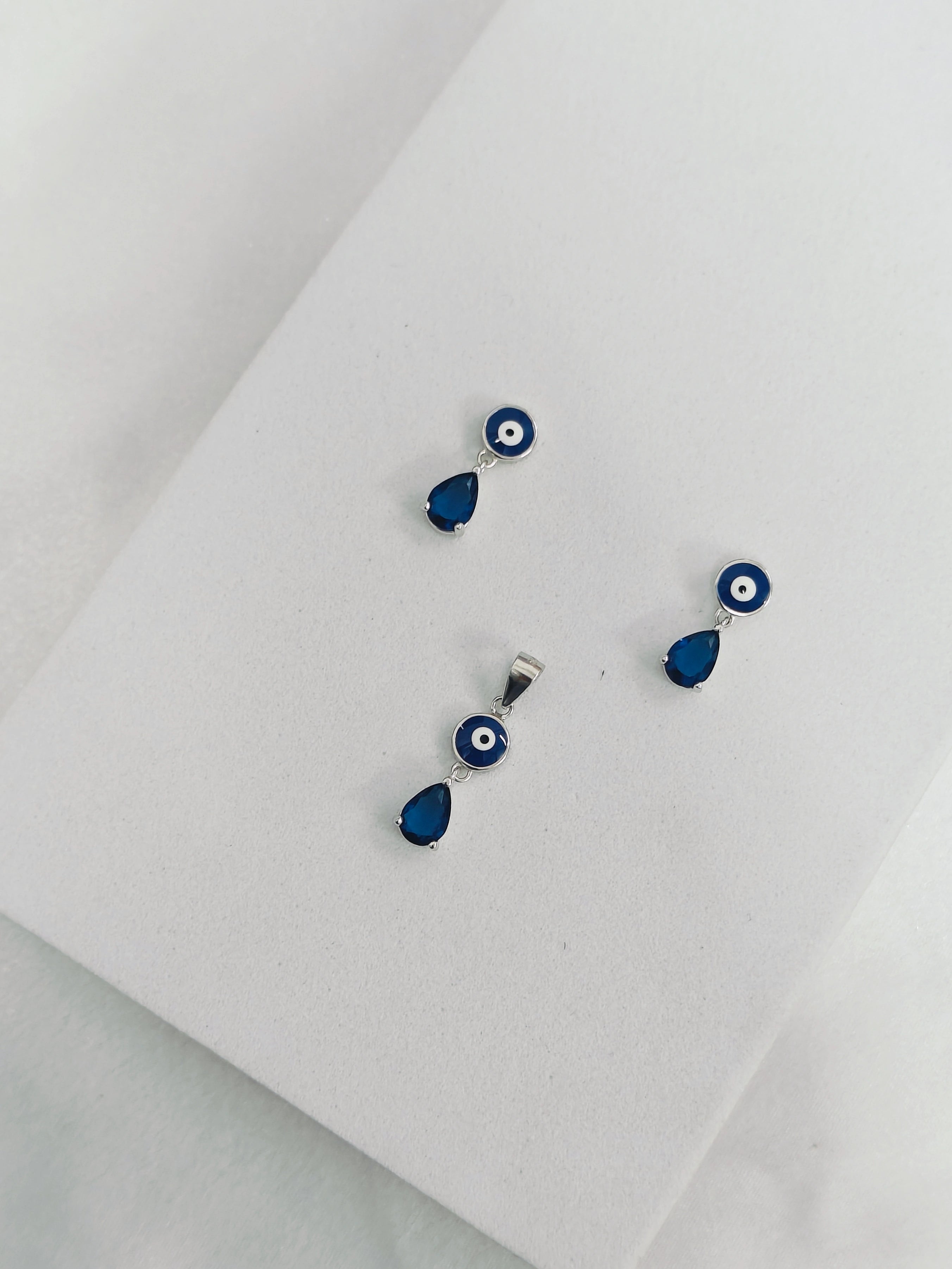 Blue evil eye earrings on a white background