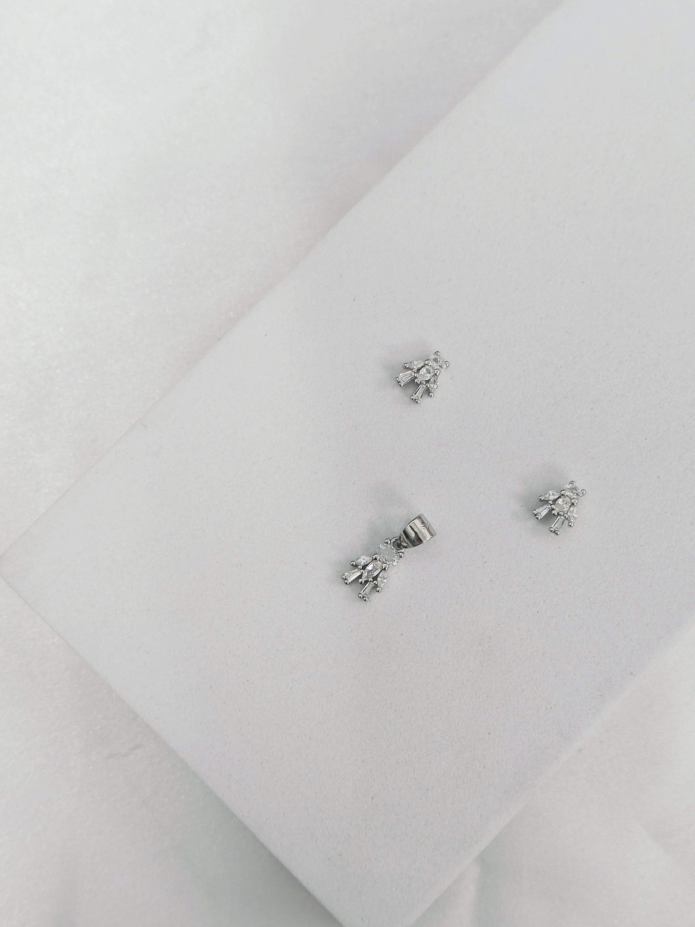 Pair of silver earrings on a light gray background