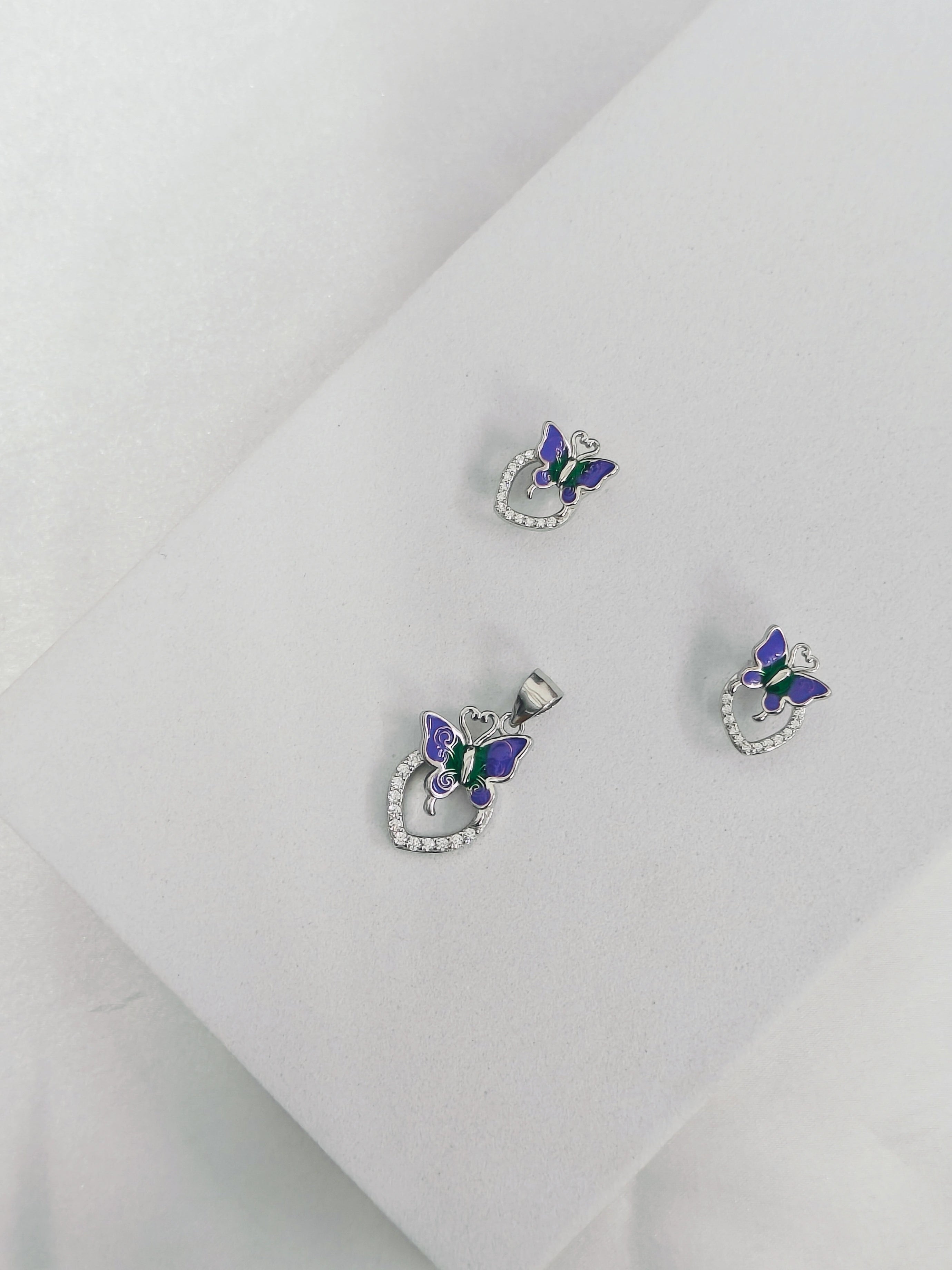 Butterfly-shaped earrings on a light gray background