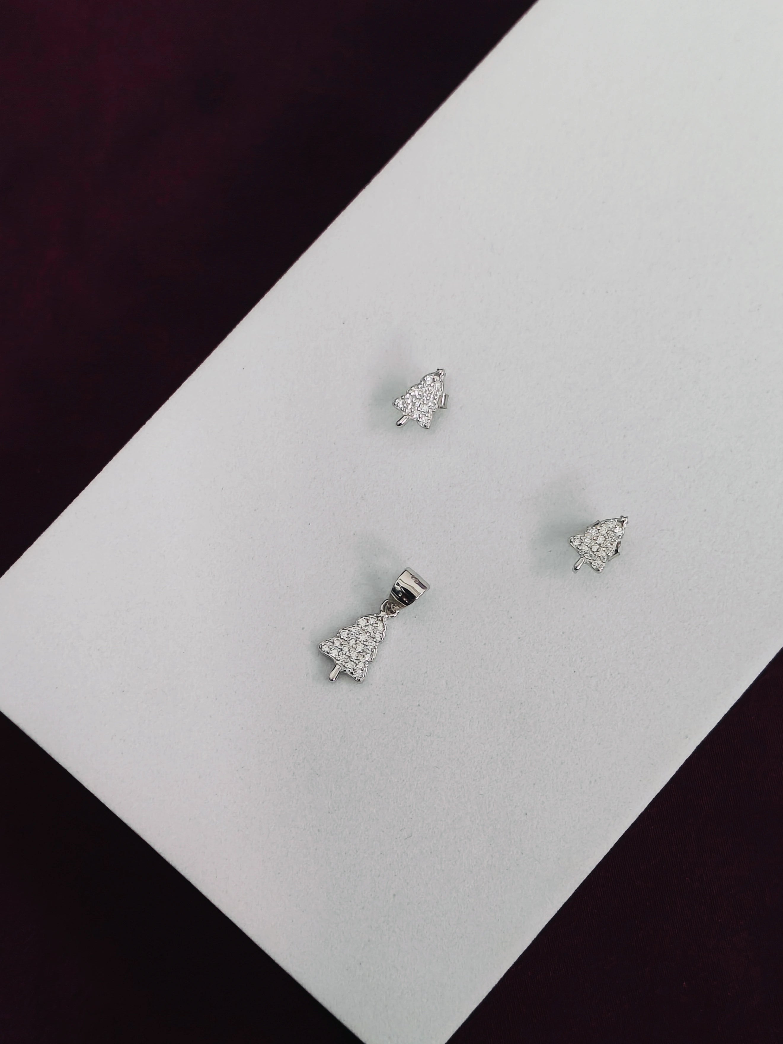 Silver earrings with clear stones on a white card