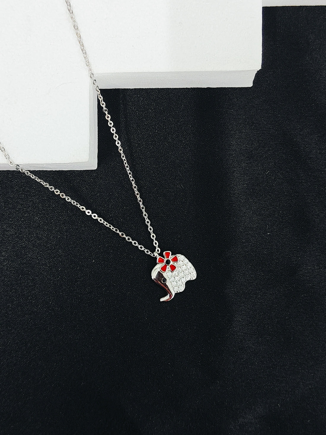 Necklace with a pendant on a black surface