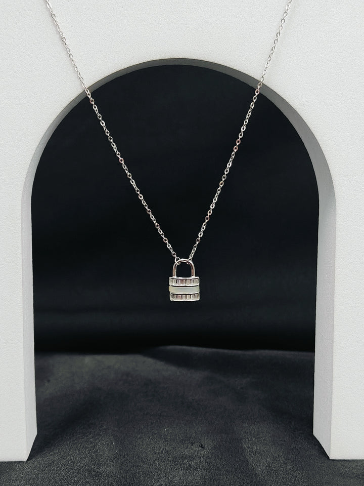 Silver padlock necklace on a dark background
