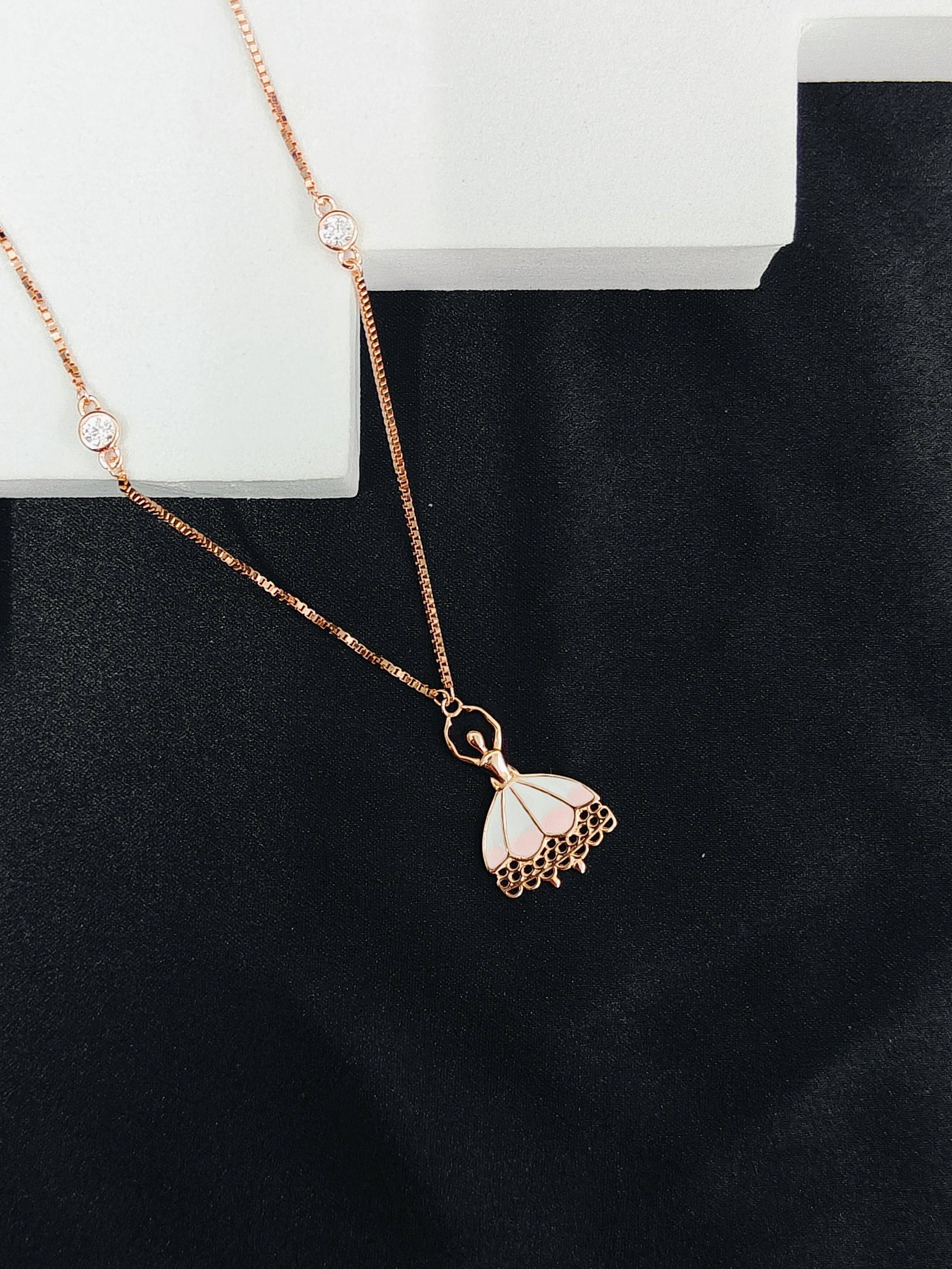 Rose gold necklace with a butterfly pendant on a black background