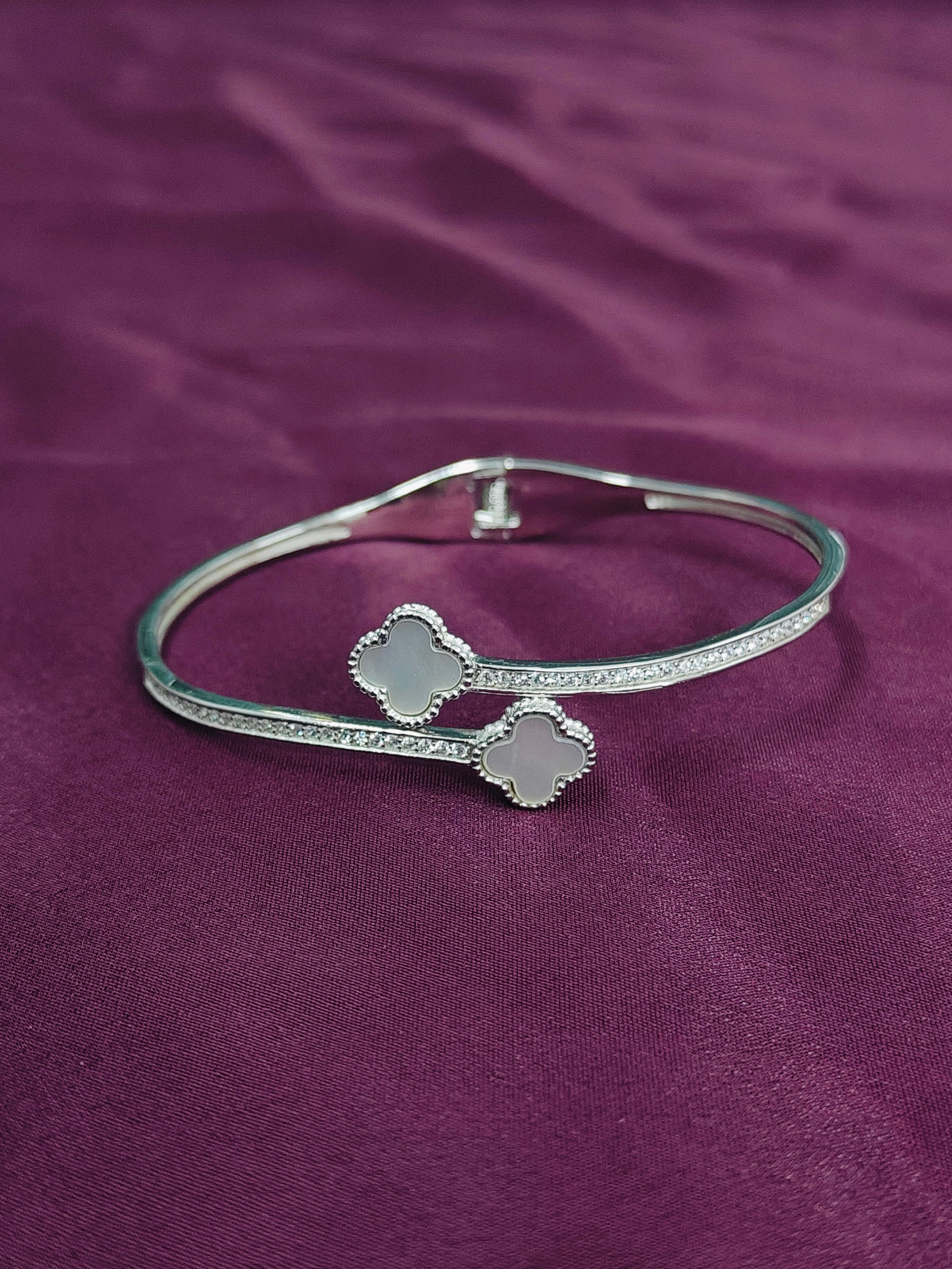 Silver bracelet on a purple fabric background