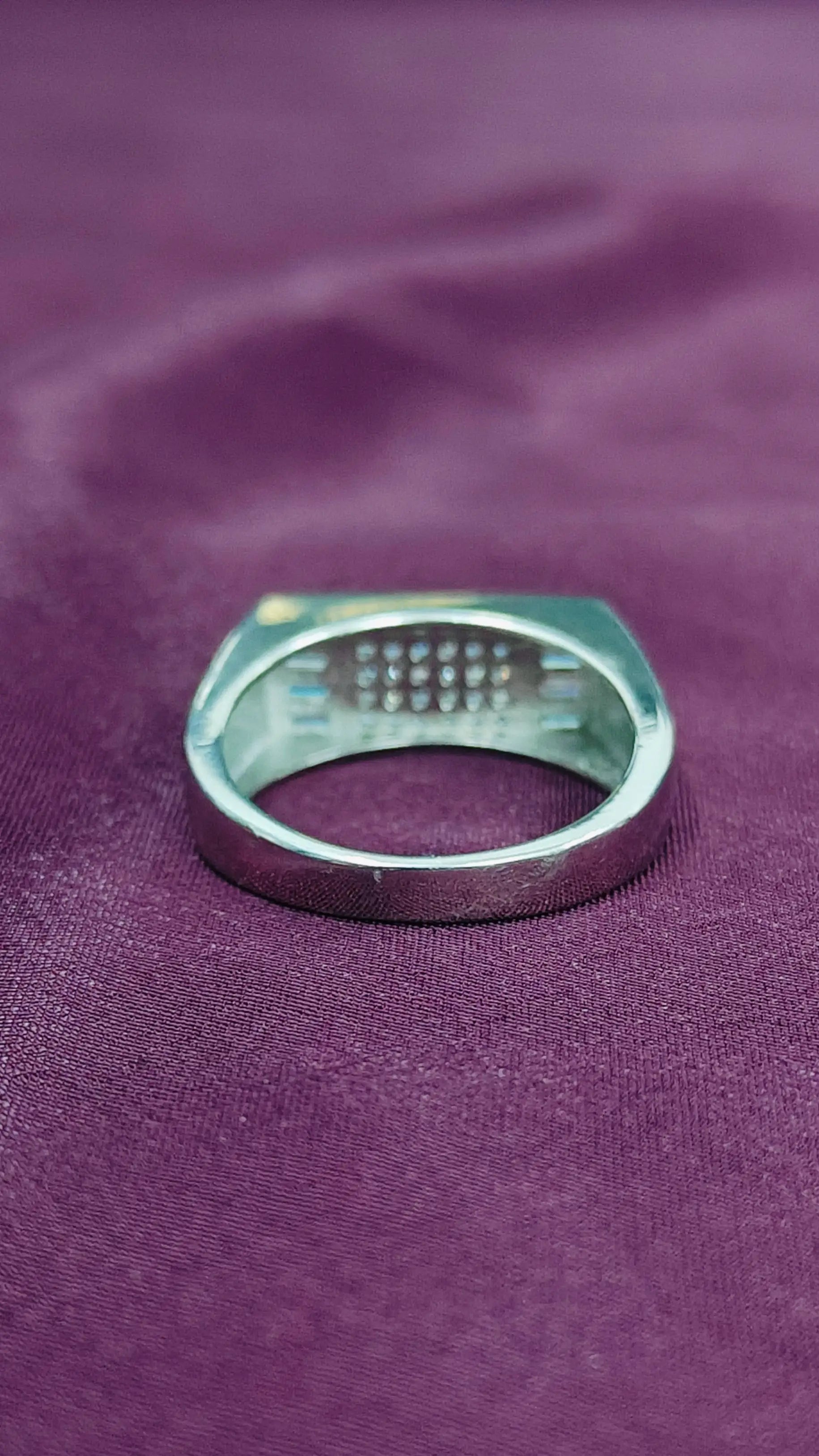 Metallic ring on a purple fabric background