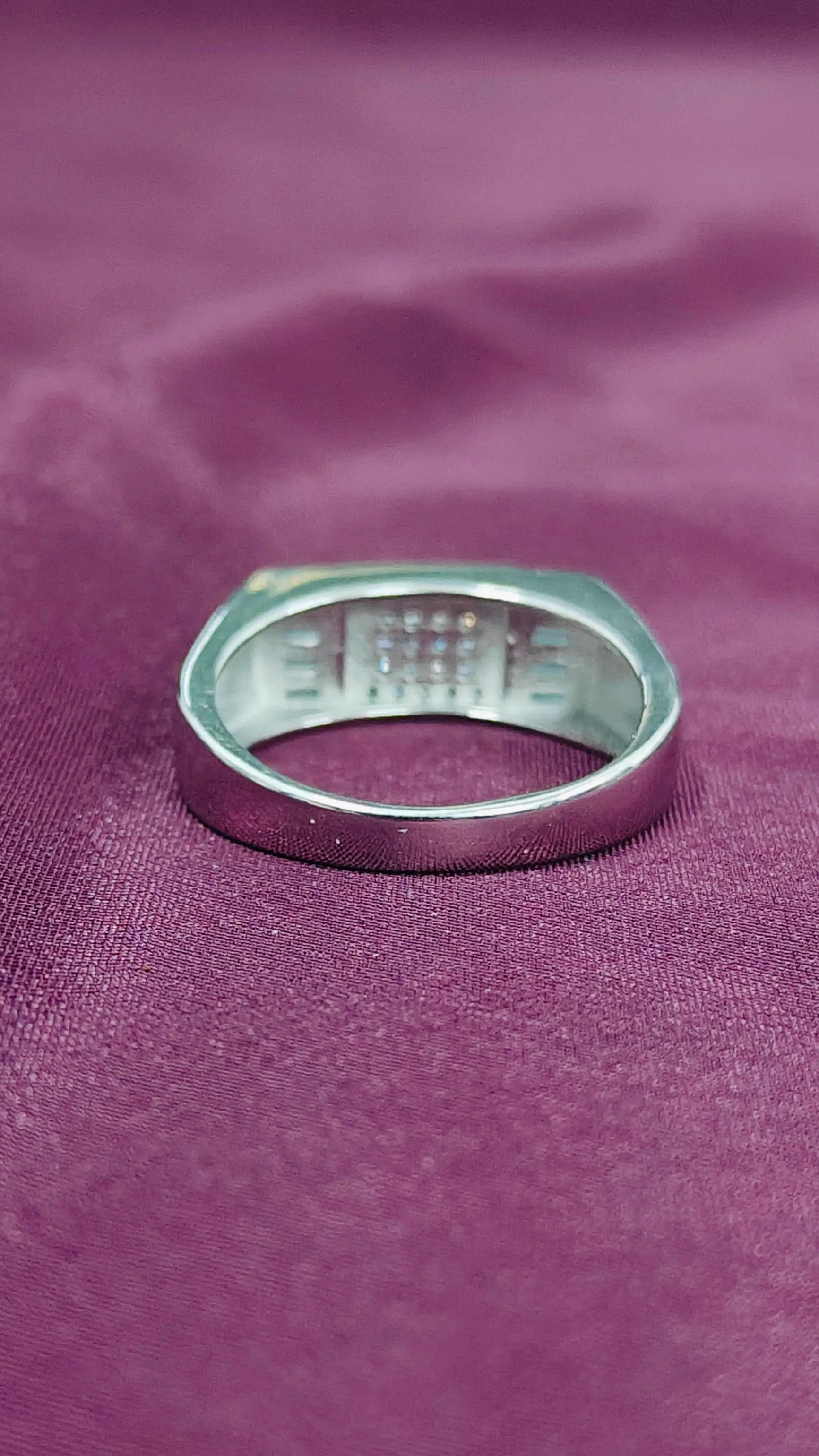 Silver ring on a purple fabric background