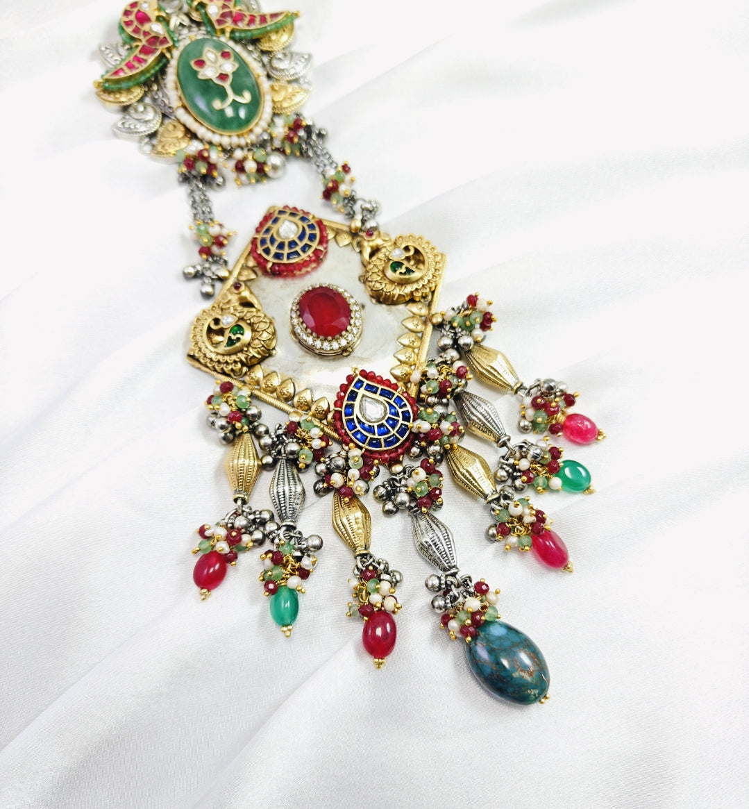 Colorful beaded necklace with gold accents on a white background