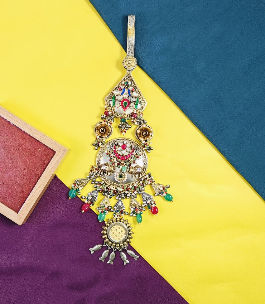 Decorative hanging ornament with colorful gemstones on a multicolored background