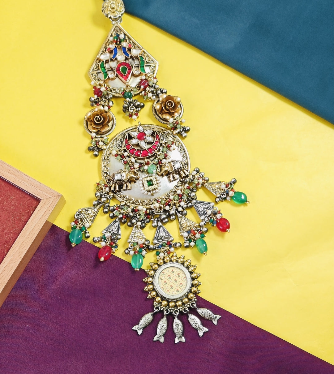 Decorative pendant with colorful beads on a multicolored background