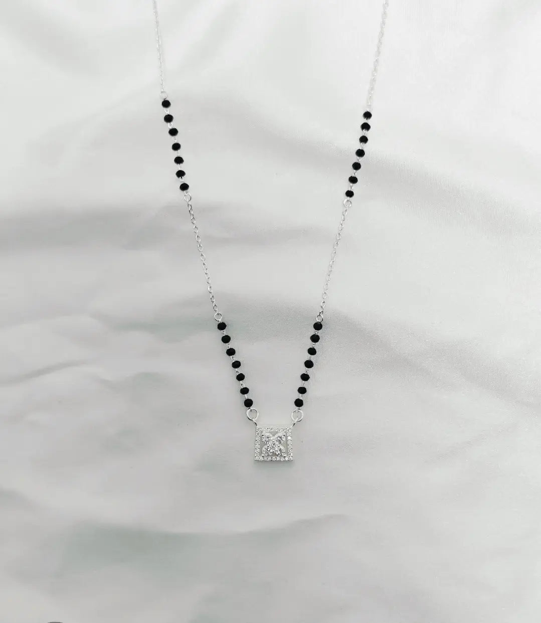 Necklace with a square pendant on a white background