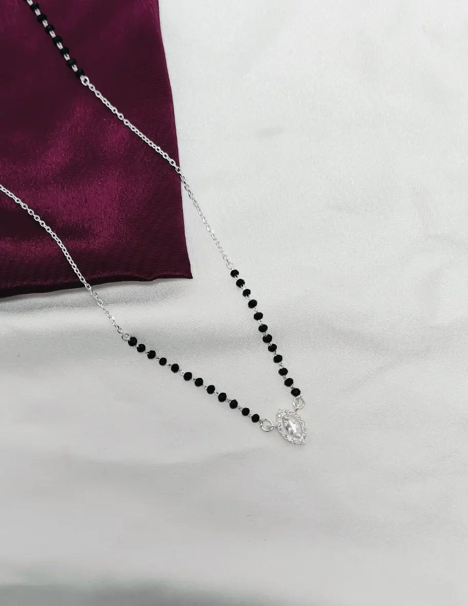 Necklace with black beads and a silver clasp on a white background
