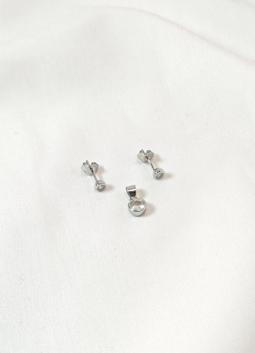 Set of silver earrings on a white background