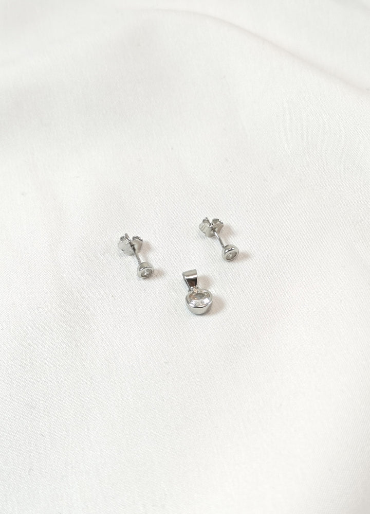 Set of silver earrings on a white background